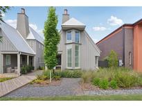 Charming home exterior with manicured landscaping, stone pathway, and modern gray facade at 135 Channing Ln, Fayetteville, GA 30214