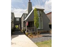 Charming home with a covered porch, gray siding, and stone landscaping at 135 Channing Ln, Fayetteville, GA 30214