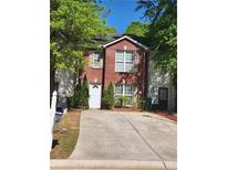 Charming two-story brick home with a well-maintained front yard and a driveway at 3336 Waldrop Trl, Decatur, GA 30034