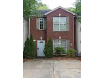 Charming red brick home featuring a light blue front door, green shrubbery and well-kept landscaping at 3336 Waldrop Trl, Decatur, GA 30034