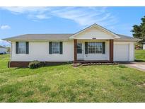 Charming single-story home with a well-maintained lawn, brick accents, and a cozy front porch at 5794 Parks Rd, Cumming, GA 30041