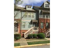 Charming townhouse featuring a blend of brick and siding, complemented by well-maintained landscaping at 1186 Ridenour Blvd # 5, Kennesaw, GA 30152