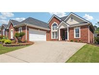 Charming brick home features a two-car garage and beautiful landscaping at 5832 Sloane St, Douglasville, GA 30135