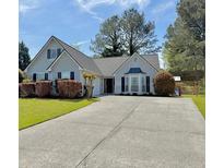 Charming single-Gathering home with well-manicured lawn, long driveway, and inviting curb appeal at 1325 Richland Creek Ct, Sugar Hill, GA 30518
