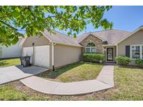Charming single-story home with a well-manicured lawn and a two-car garage, creating a welcoming curb appeal at 4719 Score Ct, Snellville, GA 30039