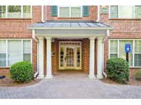 Welcoming brick building entrance featuring white columns and double glass doors with an accessible entrance sign at 2103 Stratford Commons, Decatur, GA 30033