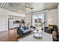 Bright living room featuring modern furnishings and a walk-out balcony with city views at 620 Glen Iris Ne Dr # 410, Atlanta, GA 30308
