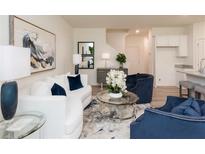 Bright living room showcasing modern decor, plush seating, and contemporary artwork for a comfortable and stylish ambiance at 1573 Aiden Way # 37, Conyers, GA 30013