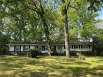 Charming single-story home with lush green lawn and mature trees providing ample shade at 2963 Williams Pl, Snellville, GA 30078