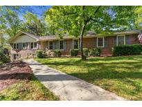 Charming brick home with well-maintained landscaping and a sidewalk leading to the entrance at 3982 Battleford Ct, Atlanta, GA 30341