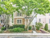 Charming two-story home with stone accents, inviting front porch, and lush landscaping at 2238 Parkview Nw Ct, Atlanta, GA 30318