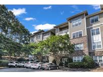 Attractive multi-level condo building with beige siding and manicured landscaping at 2700 Pine Tree Ne Rd # 1015, Atlanta, GA 30324