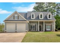 Charming two-story home with a well-manicured lawn, two car garage and inviting front porch at 17 Brightwater Cv, Dallas, GA 30157