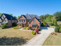 Beautiful brick home with a well-manicured lawn and long driveway leading to the front entrance at 2199 Tayside Nw Xing, Kennesaw, GA 30152