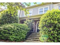Charming home exterior featuring stone steps, a brick facade, and well-maintained landscaping with lush greenery at 225 Mystic Ridge Hl, Sandy Springs, GA 30342
