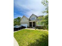 Traditional two-story home with a covered front porch and an attached two-car garage at 4346 Traipse Path, Ellenwood, GA 30294