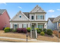 Charming two-story home with manicured lawn and inviting front porch with easy access to nearby road at 1536 Drew Nw Dr, Atlanta, GA 30318