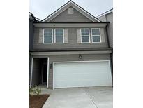 Two-story home featuring gray siding, a white garage door, and complementary light gray window shutters at 1120 Edinberg Dr # 61, Villa Rica, GA 30180