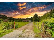 Charming country home featuring a spacious yard and driveway with beautiful sunset views at 1277 Bethany Rd, Covington, GA 30016