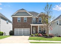 Charming two-story brick home with a manicured lawn and inviting front porch at 244 Walnut Ridge Rd, Canton, GA 30115