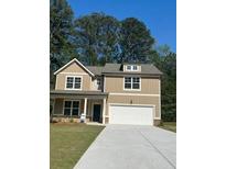 Charming two-story home with a well-manicured lawn, inviting curb appeal, and a convenient two-car garage at 2706 Sw Riverpine Lot 176 Sw Trl, Atlanta, GA 30331