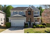 Charming two-story home with a brick facade and well-manicured lawn at 985 Forest Knoll Court, Lithia Springs, GA 30122