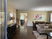 Inviting living and dining area with hardwood floors, neutral paint, and stylish furnishings. A perfect flow for gatherings at 985 Forest Knoll Court, Lithia Springs, GA 30122