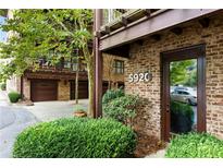 Brick exterior with garage and well-maintained landscaping; unit number 5920 is visible near the front door at 5920 Bond St # B206, Cumming, GA 30040