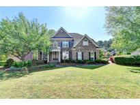 Beautiful two-story brick home with manicured lawn and mature trees in an established neighborhood at 1806 Royal Troon Ct, Duluth, GA 30097