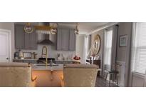Bright kitchen features gray cabinets, gold fixtures, stainless steel appliances, and a stylish center island at 1179 Bennett Creek Overlook, Suwanee, GA 30024