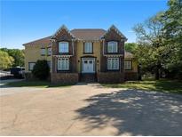 Stately two-story home boasts a circular driveway and manicured lawn at 1081 Humphries Nw Rd, Conyers, GA 30012