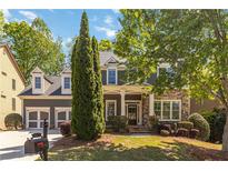Charming two-story home with a stone and siding facade, well-manicured lawn, and attached two-car garage at 617 Wexford Ct, Acworth, GA 30102