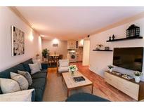Inviting living room featuring a comfortable sofa, stylish decor, and an open layout to the dining and kitchen areas at 1181 Church St # D, Decatur, GA 30030
