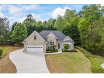 Charming brick home featuring an attached two-car garage, manicured lawn, and lush landscaping at 3601 Cedar Springs Ln, Loganville, GA 30052