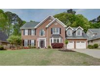 Charming two-story brick home with manicured lawn and a two car garage at 3011 Oak Hampton Ct, Duluth, GA 30096