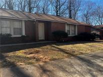 Cozy single-story home with brick and wood accents and a well-maintained lawn at 4071 River Rd, Ellenwood, GA 30294