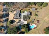 Expansive property showcasing a charming home with a private pool, outbuildings and generous acreage at 813 Sandy Creek Rd, Fayetteville, GA 30214