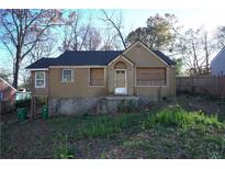 Exterior shot of an older home with tan siding and newer roof at 2055 Marco Dr, Decatur, GA 30032