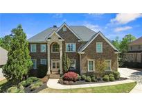 Beautiful brick home with well-manicured landscaping and a classic architectural design at 5204 Heron Bay Blvd, Locust Grove, GA 30248