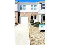 Charming two-story townhome with a one-car garage and well-maintained front yard at 6408 Kennonbriar Ct, Lithonia, GA 30058