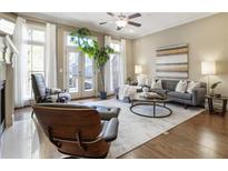 Bright living room featuring hardwood floors, a ceiling fan, and a cozy seating arrangement at 25 High Gate Trail, Atlanta, GA 30030
