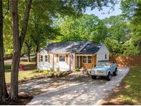 Charming single story home featuring a gravel driveway, manicured landscaping, and a classic, all-American aesthetic at 2086 Harold Se Ave, Smyrna, GA 30080