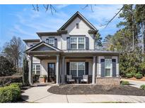 Charming two-story home featuring a welcoming front porch, well-manicured landscaping, and inviting curb appeal at 2005 Etris Manor Dr, Roswell, GA 30075