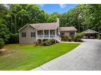 Charming single-Gathering home with a well-manicured front yard and inviting front porch at 6865 Fletcher Dr, Winston, GA 30187