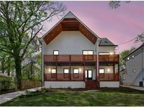 Stunning two-story home featuring a modern design, wooden balconies, and a meticulously manicured lawn at 1882 Francis Nw Ave, Atlanta, GA 30318