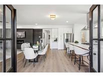 Bright living room features sleek fireplace, dining area, and open kitchen layout at 1882 Francis Nw Ave, Atlanta, GA 30318