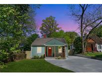 Charming home with a red door, lovely landscaping and a concrete driveway at 1518 Langston Sw Ave, Atlanta, GA 30310
