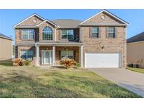 Charming two-story brick home with a well-manicured lawn and inviting front porch at 5840 Harrier Ln, Atlanta, GA 30349