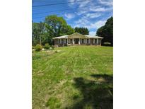 Charming brick home with a well-manicured lawn and inviting front porch at 2126 Monterey Dr, Snellville, GA 30039
