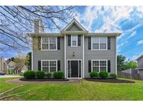 Charming two-story home with gray siding, black shutters, manicured lawn, and a welcoming front entrance at 2154 Windstream Sw Way, Marietta, GA 30060